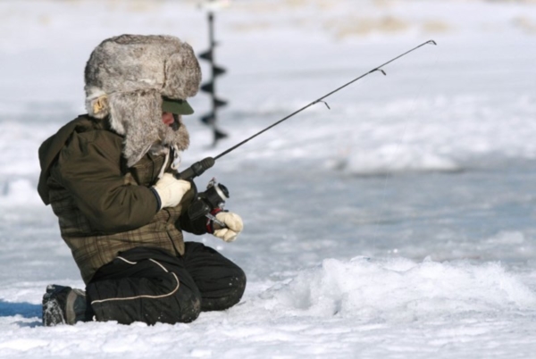 Young person ice fishing.